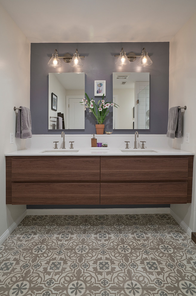Photo of a large master bathroom in DC Metro with flat-panel cabinets, medium wood cabinets, an alcove shower, a two-piece toilet, white tile, ceramic tile, purple walls, cement tiles, an undermount sink, solid surface benchtops, brown floor, a hinged shower door, white benchtops, a shower seat, a double vanity and a floating vanity.
