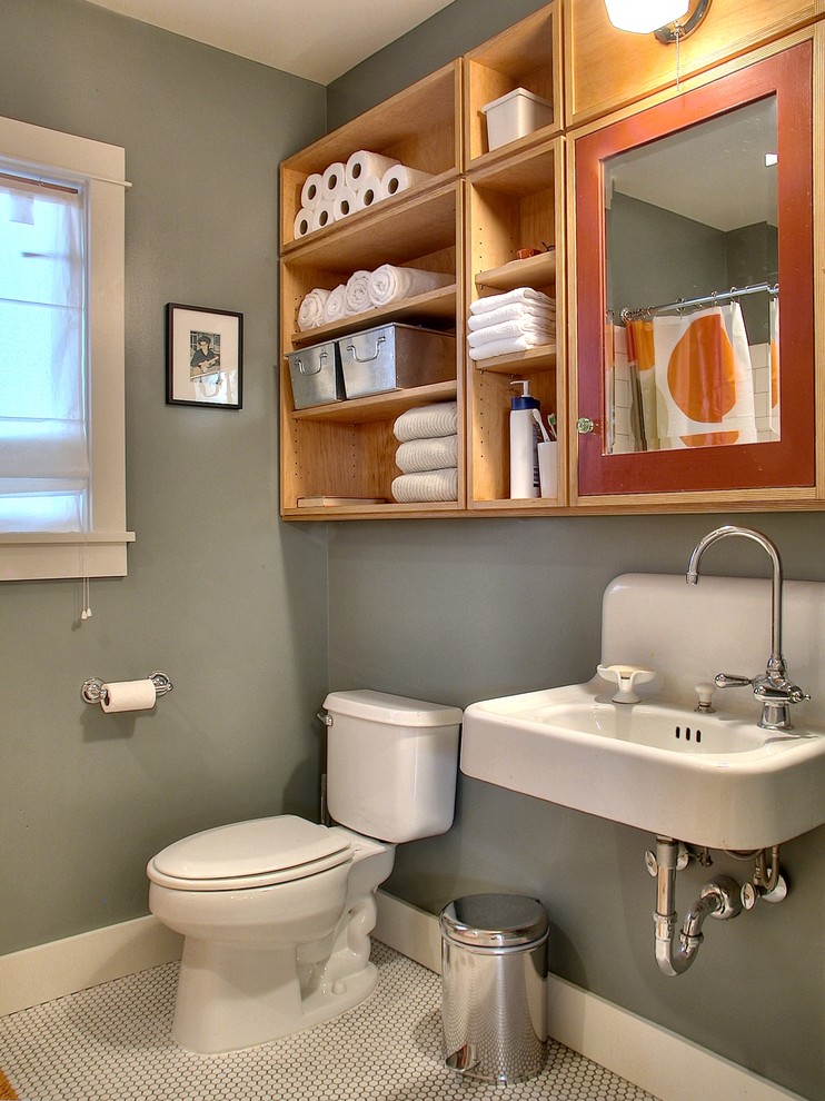 Photo of a small arts and crafts kids bathroom in Seattle with a wall-mount sink, flat-panel cabinets, medium wood cabinets, an alcove shower, a two-piece toilet, white tile, porcelain tile, porcelain floors and grey walls.