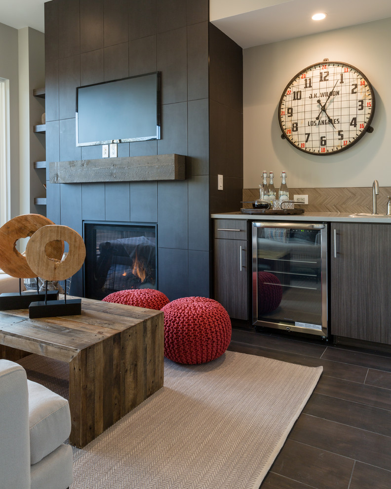 Mid-sized industrial open concept family room in Denver with a standard fireplace, a tile fireplace surround, a wall-mounted tv, brown walls and ceramic floors.