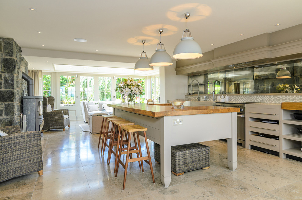 Inspiration for a traditional kitchen in Belfast with flat-panel cabinets, grey cabinets, wood benchtops, multi-coloured splashback, mosaic tile splashback and with island.