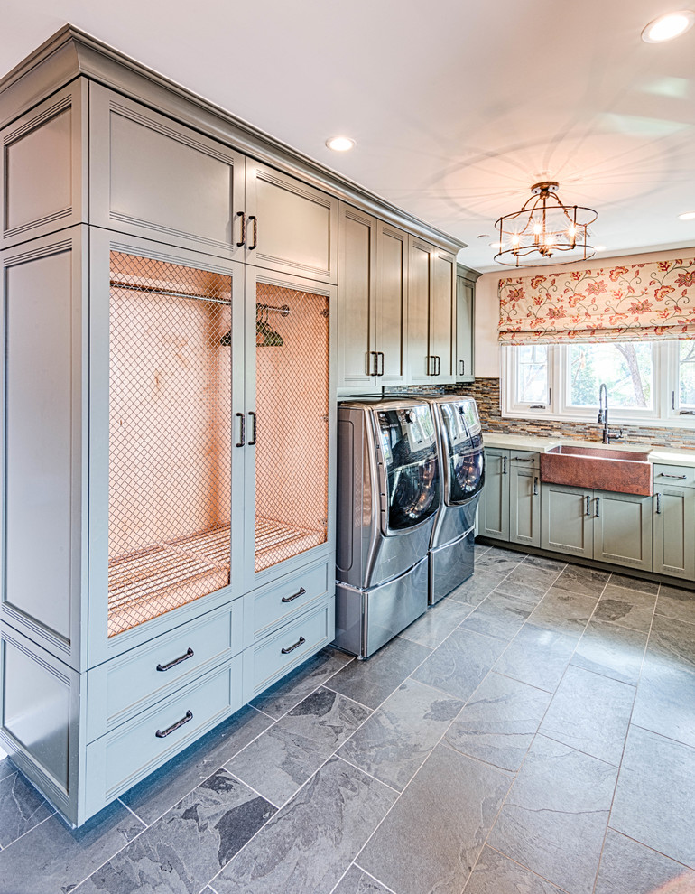 Large transitional u-shaped slate floor and gray floor dedicated laundry room photo in Los Angeles with a farmhouse sink, recessed-panel cabinets, green cabinets, quartzite countertops, white walls, a side-by-side washer/dryer and white countertops