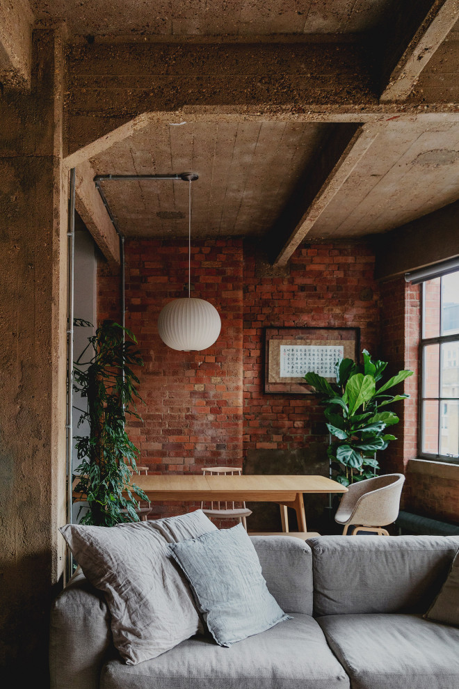 Inspiration for a mid-sized industrial open plan dining in London with red walls and brick walls.