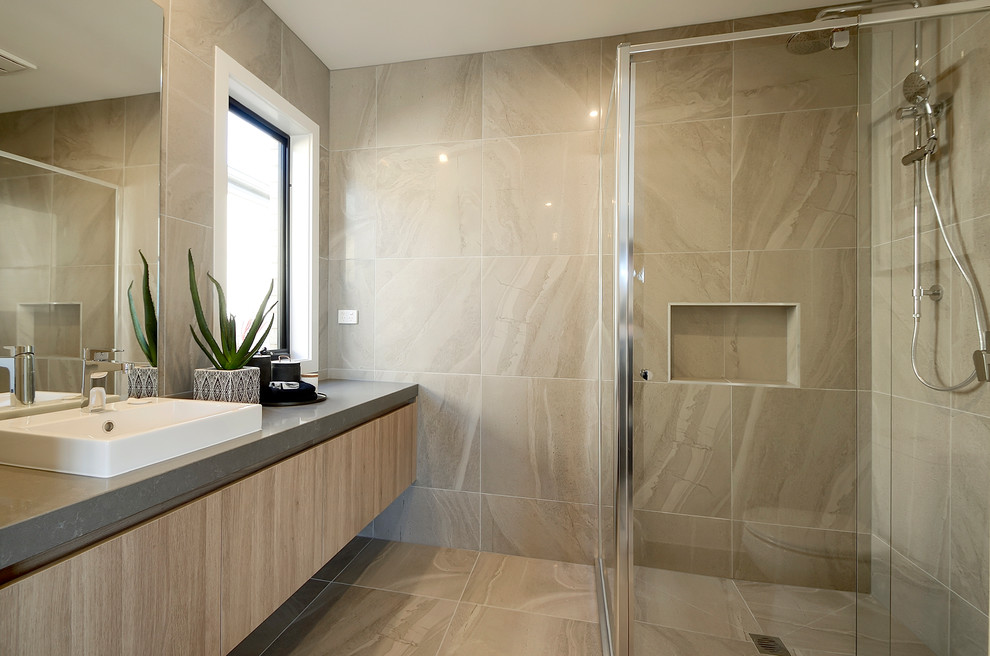 Inspiration for a mid-sized contemporary master bathroom in Melbourne with light wood cabinets, a drop-in tub, a corner shower, gray tile, porcelain tile, grey walls, porcelain floors, a drop-in sink, engineered quartz benchtops, grey floor and a hinged shower door.