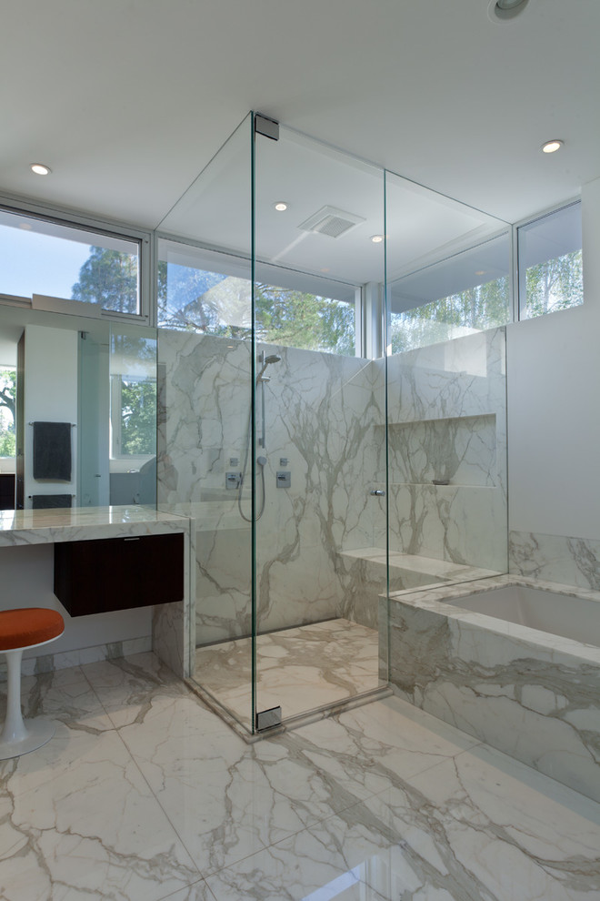 Photo of a modern bathroom in San Francisco with an undermount sink, flat-panel cabinets, dark wood cabinets, a corner shower and white tile.