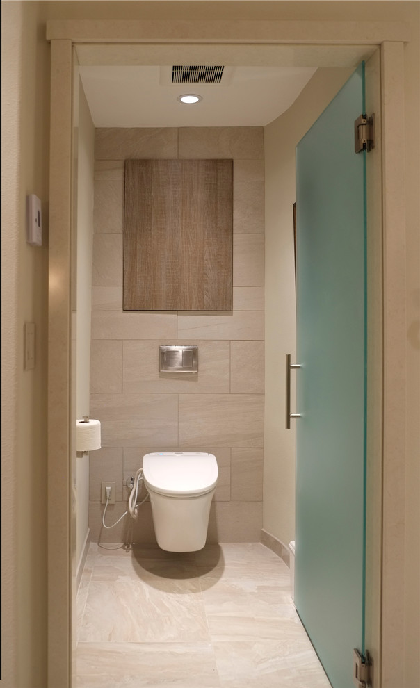 Photo of a mid-sized contemporary master bathroom in Seattle with an undermount sink, flat-panel cabinets, light wood cabinets, engineered quartz benchtops, a curbless shower, a wall-mount toilet, beige tile, porcelain tile, beige walls and porcelain floors.