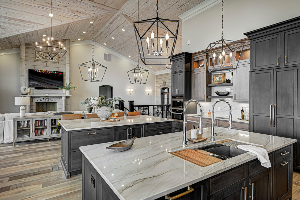Design ideas for a mid-sized contemporary galley open plan kitchen in Indianapolis with shaker cabinets, medium wood cabinets, marble benchtops, white splashback, marble splashback, medium hardwood floors, multiple islands, white benchtop, wood, brown floor and an undermount sink.