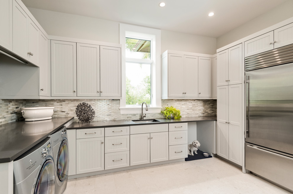 Inspiration for a laundry room in Other with white cabinets and a side-by-side washer and dryer.