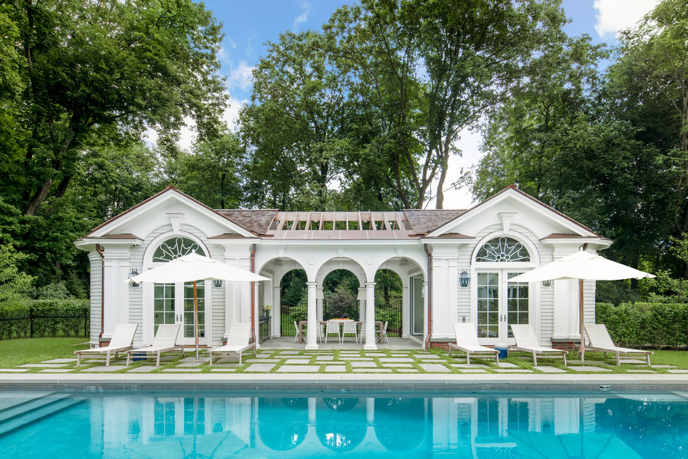 Inspiration for a beach style backyard rectangular pool in New York with a pool house.