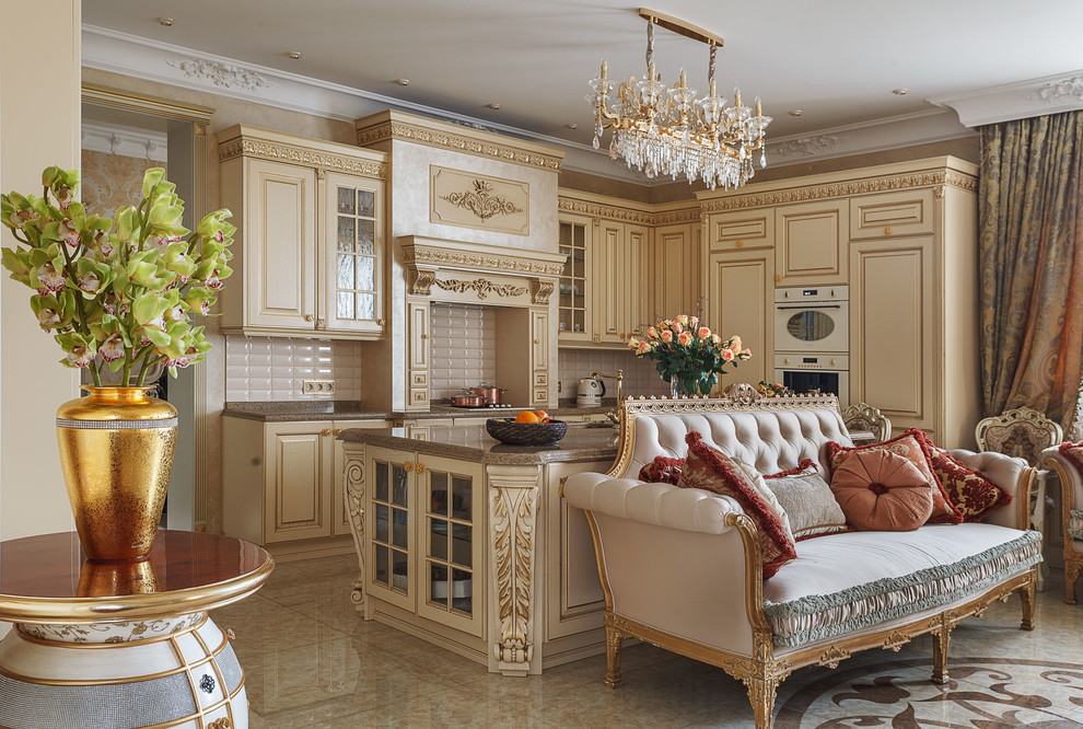 This is an example of a mid-sized traditional l-shaped open plan kitchen in Moscow with raised-panel cabinets, beige cabinets, beige splashback, subway tile splashback, white appliances, with island and beige floor.