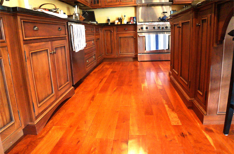 Eat-in kitchen - mid-sized rustic l-shaped medium tone wood floor eat-in kitchen idea in New York with an undermount sink, shaker cabinets, distressed cabinets, granite countertops, multicolored backsplash, stone slab backsplash, stainless steel appliances, yellow walls and an island