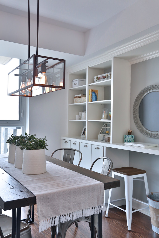 This is an example of a transitional dining room in Toronto with grey walls and dark hardwood floors.