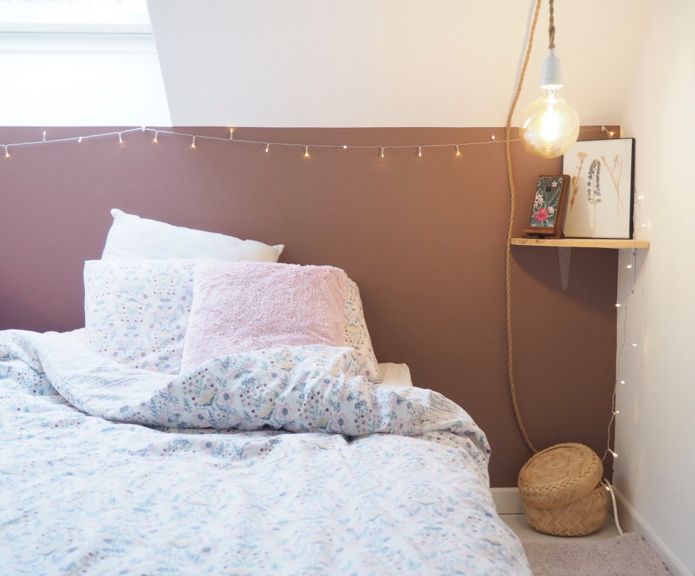 Design ideas for a small scandi guest bedroom with pink walls, laminate floors, no fireplace and white floors.