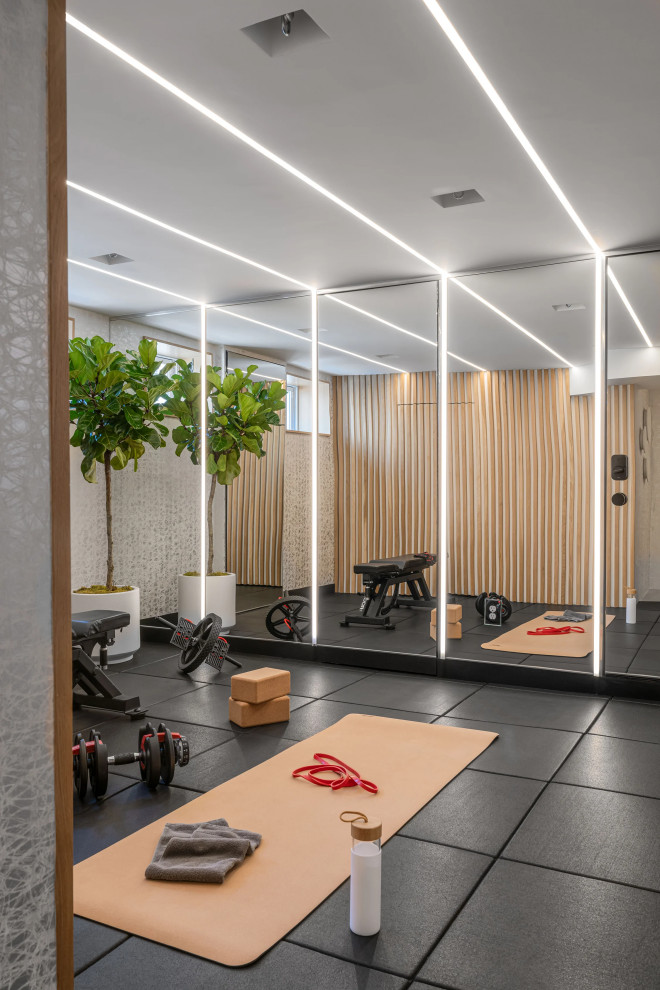 Example of a small trendy black floor home weight room design in Boston with white walls
