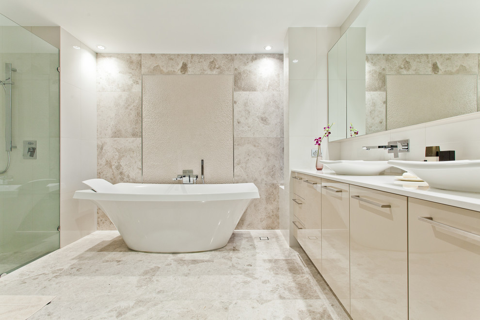 Inspiration for a contemporary bathroom in Perth with a vessel sink, flat-panel cabinets, beige cabinets, a freestanding tub, beige tile and beige walls.