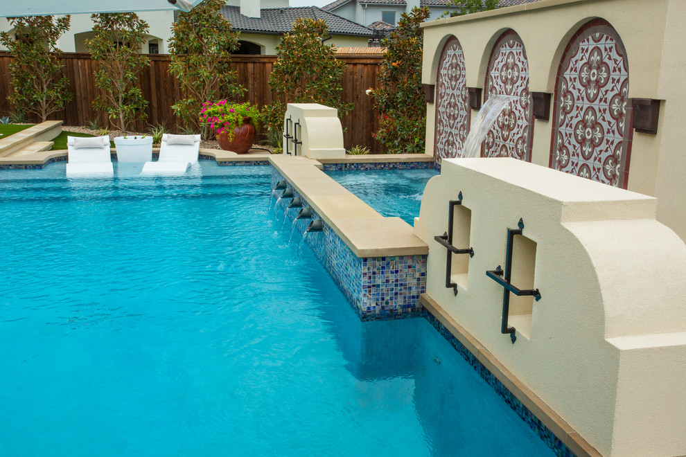 Mid-sized mediterranean backyard rectangular lap pool in Dallas with tile.
