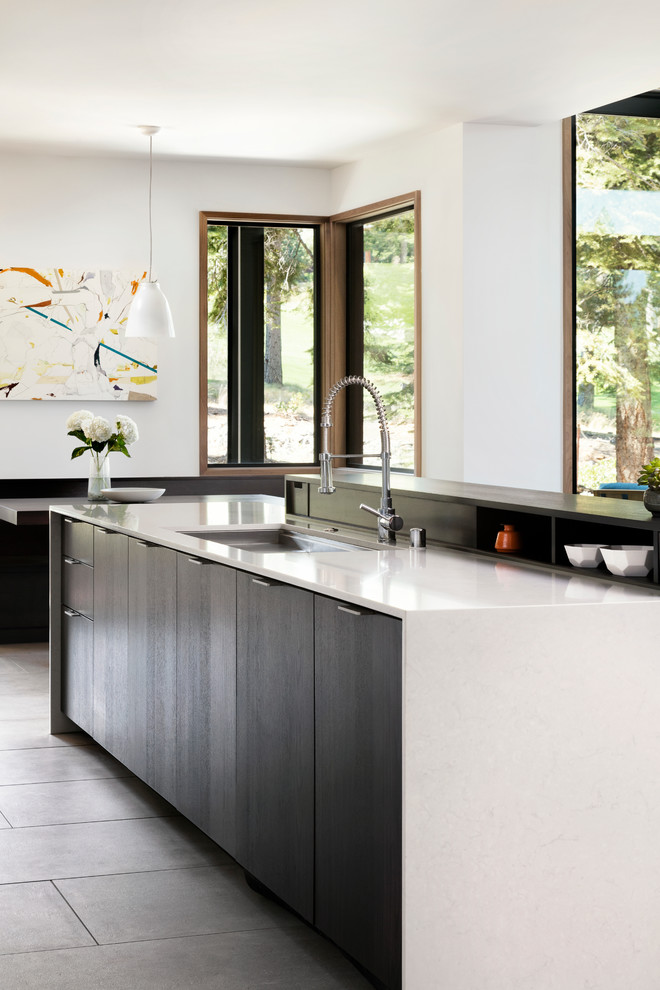 Design ideas for a large modern l-shaped open plan kitchen in San Francisco with an undermount sink, flat-panel cabinets, quartz benchtops, porcelain floors, with island, white splashback, ceramic splashback and panelled appliances.