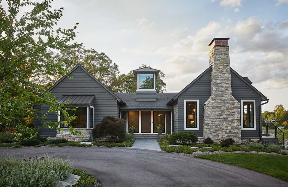 Inspiration for a large contemporary two-storey grey house exterior in Grand Rapids with vinyl siding, a shingle roof, a grey roof and clapboard siding.