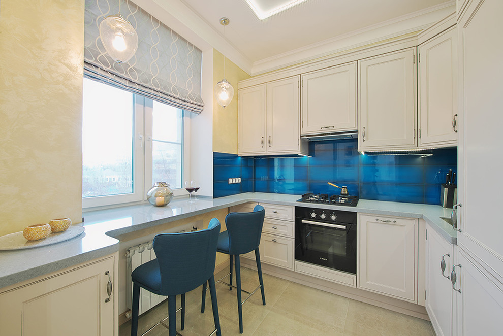 Design ideas for a small transitional eat-in kitchen in Moscow with solid surface benchtops, blue splashback, ceramic splashback, black appliances, porcelain floors, beige floor, an undermount sink, recessed-panel cabinets, white cabinets and no island.