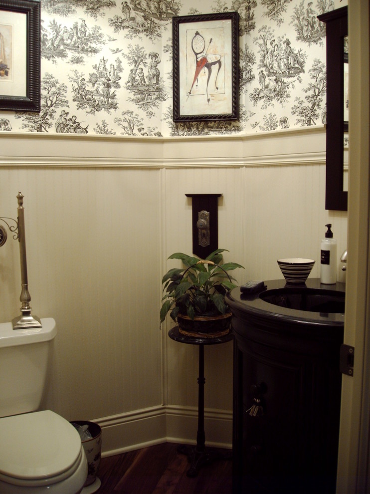 This is an example of a traditional cloakroom in Columbus with a submerged sink, a two-piece toilet, black cabinets and granite worktops.