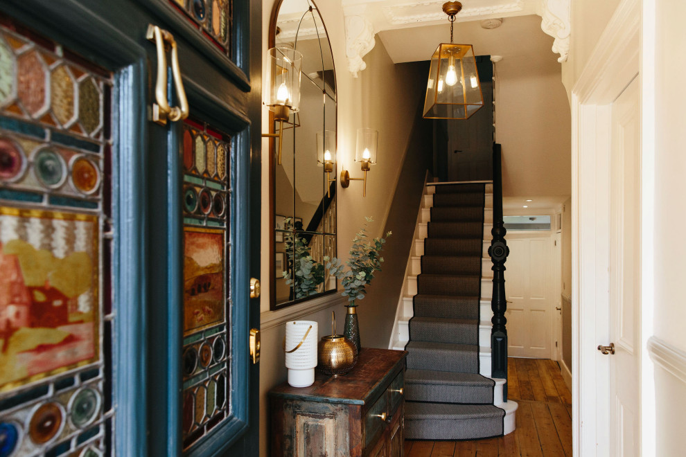 Inspiration for a mid-sized hallway in London with beige walls, dark hardwood floors and green floor.