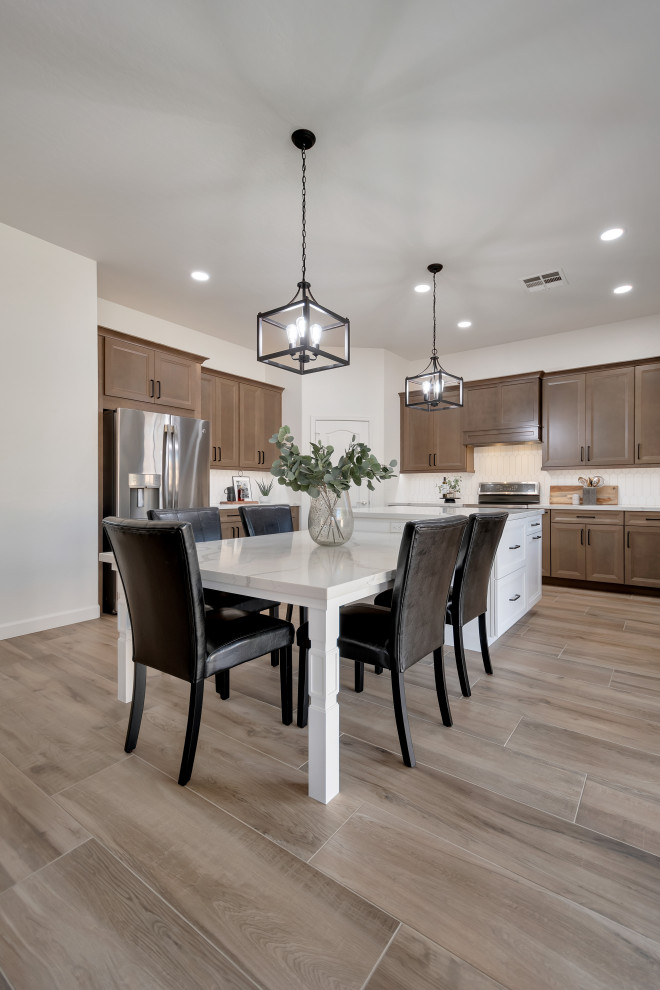Inspiration for a mid-sized transitional u-shaped ceramic tile and brown floor eat-in kitchen remodel in Phoenix with beaded inset cabinets, brown cabinets, quartzite countertops, white backsplash, ceramic backsplash, an island and white countertops
