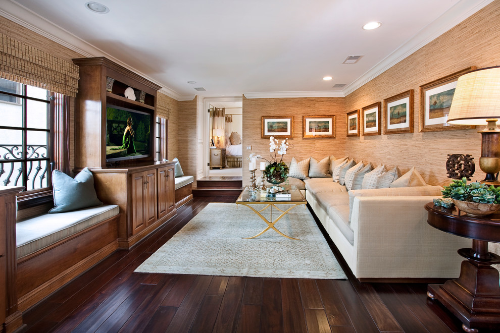 Photo of a mediterranean family room in Orange County with beige walls, dark hardwood floors and a built-in media wall.