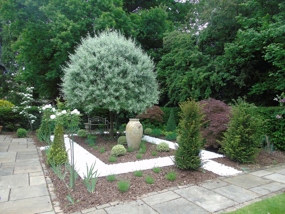 This is an example of a small traditional backyard formal garden in Cheshire.