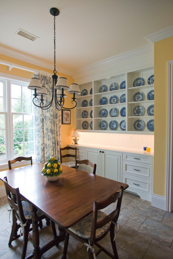 Inspiration for a mid-sized dining room in Seattle with yellow walls and porcelain floors.