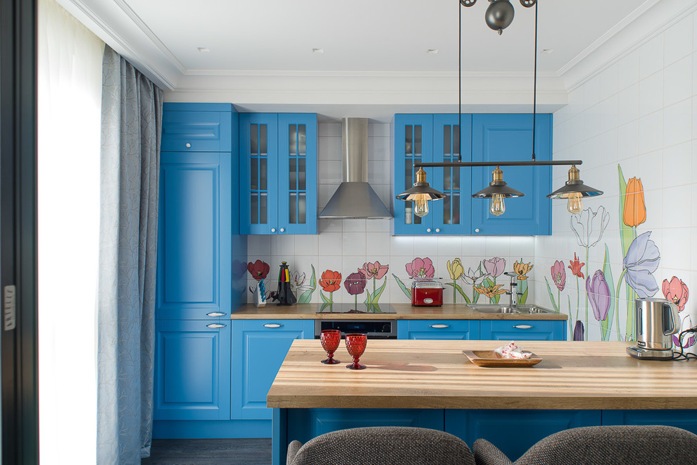 This is an example of a scandinavian galley open plan kitchen in Saint Petersburg with blue cabinets, laminate benchtops, dark hardwood floors, with island, stainless steel appliances, black floor, a drop-in sink, raised-panel cabinets and multi-coloured splashback.