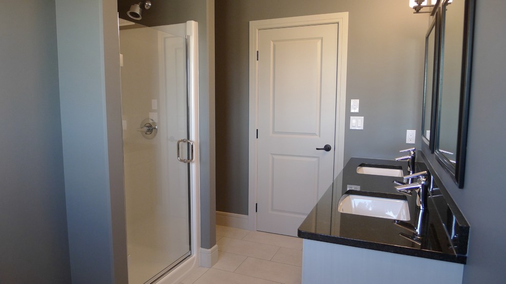 Inspiration for a small transitional master drop-in bathtub remodel with raised-panel cabinets, white cabinets, granite countertops and a hinged shower door