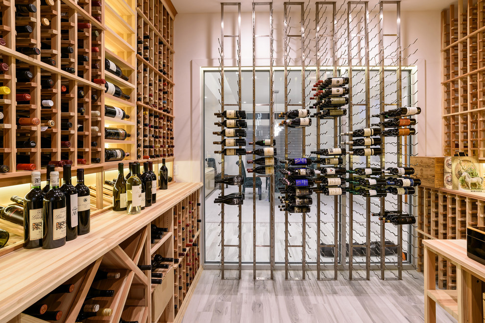Mid-sized contemporary wine cellar in Jacksonville with painted wood floors and storage racks.