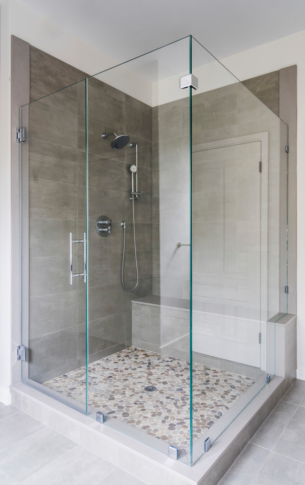 Inspiration for a mid-sized transitional master bathroom in Boston with a corner shower, gray tile, grey walls, porcelain floors, grey floor and a hinged shower door.