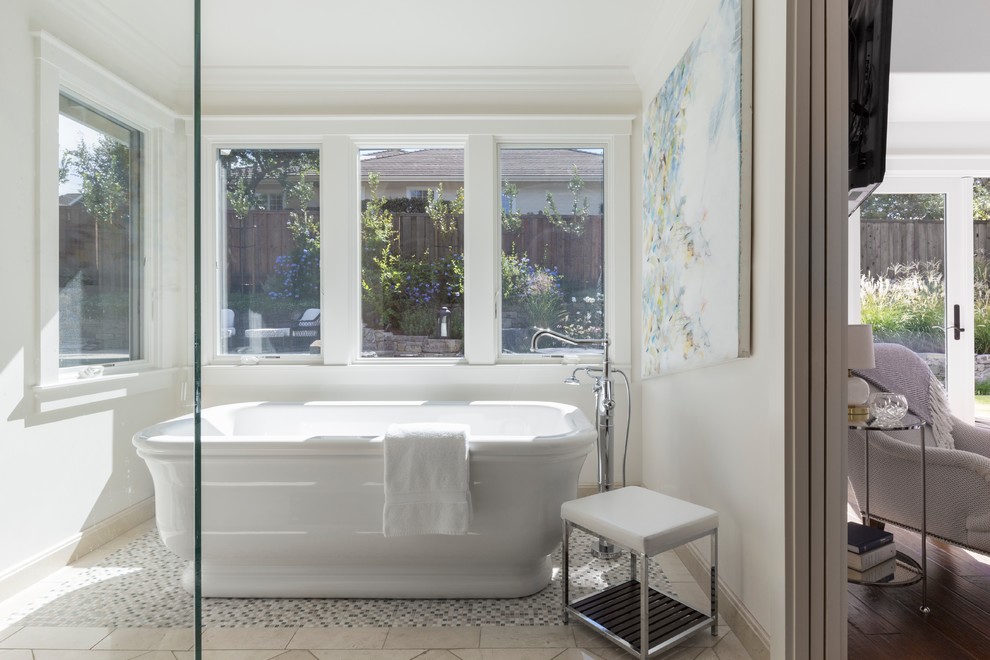 Photo of a mid-sized traditional master bathroom in San Francisco with a freestanding tub, a corner shower, white walls, marble floors, beige floor and a hinged shower door.