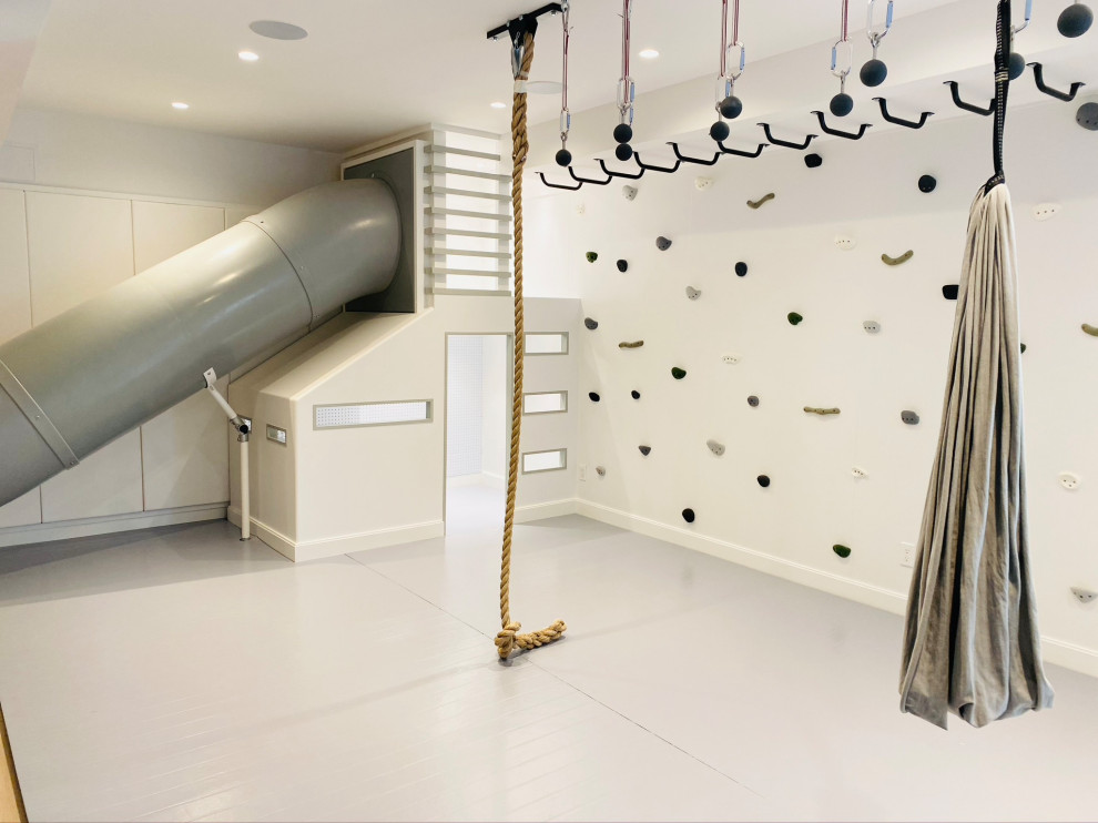 Minimalist perfection! - Mid-sized cottage gender-neutral light wood floor, gray floor, wood ceiling and wall paneling playroom photo in New York with white walls