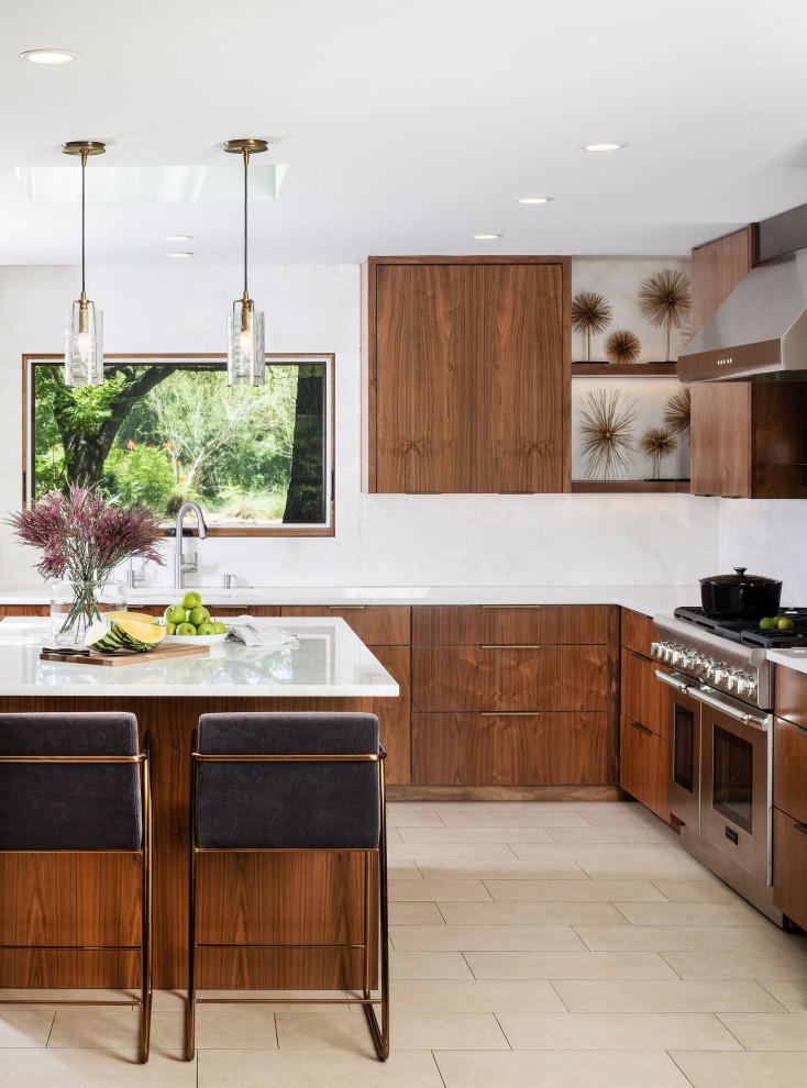 Photo of a mid-sized contemporary u-shaped open plan kitchen in Austin with an undermount sink, flat-panel cabinets, medium wood cabinets, quartzite benchtops, white splashback, stainless steel appliances, porcelain floors, with island, white floor and white benchtop.