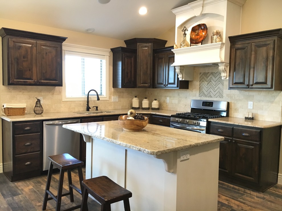 Inspiration for a large transitional u-shaped porcelain tile open concept kitchen remodel with an undermount sink, raised-panel cabinets, dark wood cabinets, granite countertops, beige backsplash, stone tile backsplash, stainless steel appliances and an island