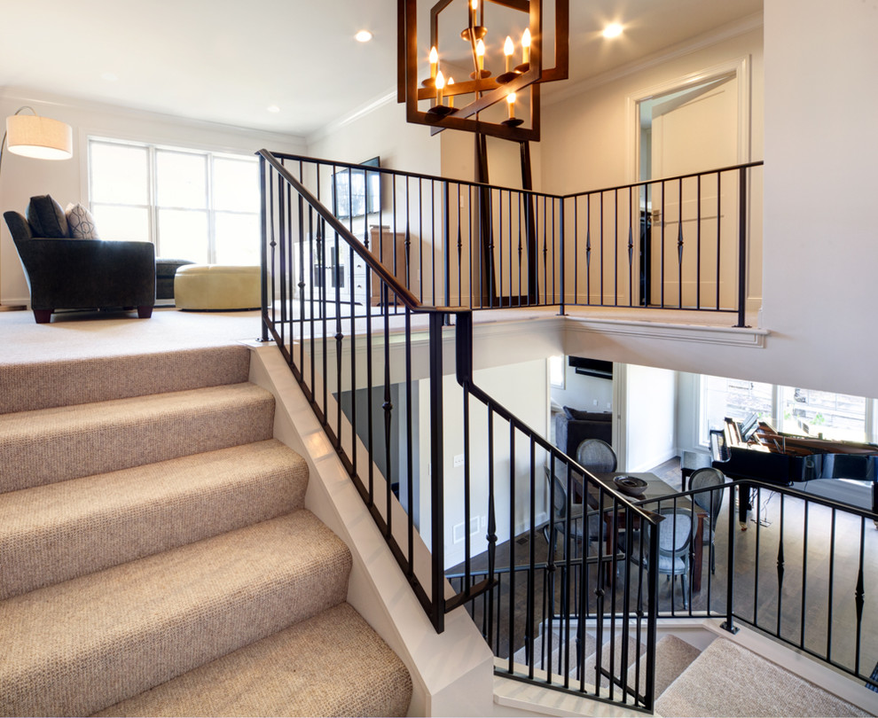 This is an example of a mid-sized traditional carpeted u-shaped staircase in Minneapolis with carpet risers.