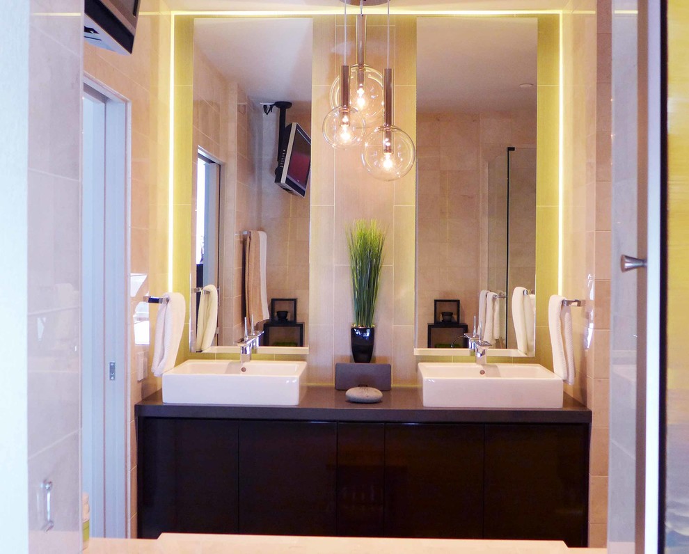 Drop-in bathtub - mid-sized modern master beige tile and porcelain tile drop-in bathtub idea in Los Angeles with a vessel sink, flat-panel cabinets, dark wood cabinets, quartz countertops and beige walls