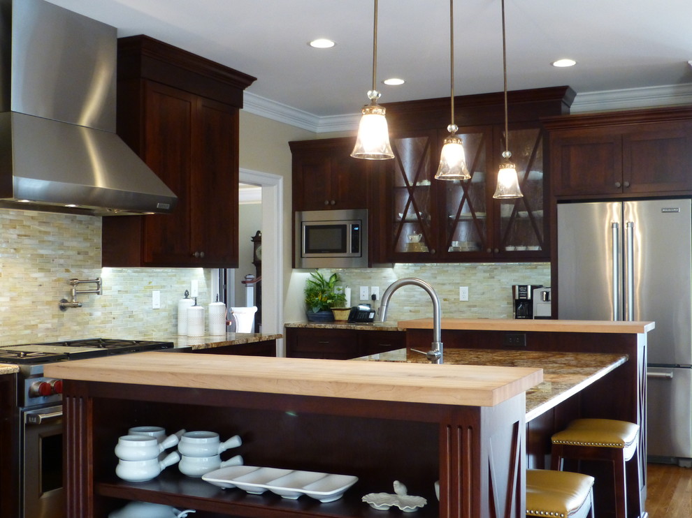 Large transitional medium tone wood floor kitchen photo in Richmond with recessed-panel cabinets, dark wood cabinets, granite countertops, beige backsplash, ceramic backsplash, stainless steel appliances and an island