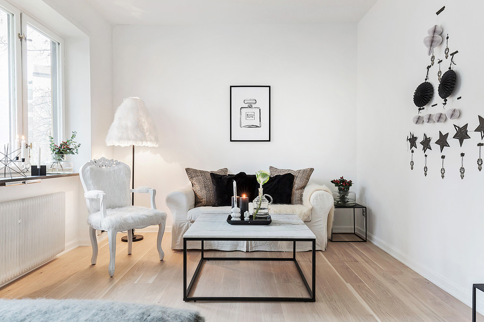 Design ideas for a mid-sized transitional formal living room in Stockholm with white walls, light hardwood floors, no fireplace and no tv.