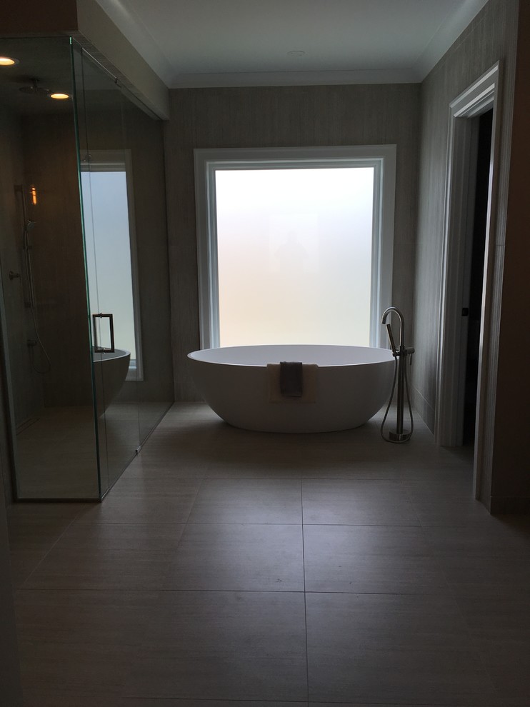 Example of a large transitional master beige tile and porcelain tile porcelain tile and beige floor home design design in Chicago with shaker cabinets, dark wood cabinets, a two-piece toilet, brown walls, an undermount sink, quartz countertops, a hinged shower door and beige countertops