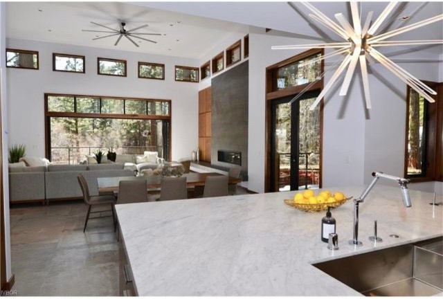 Design ideas for an expansive contemporary open plan dining in Other with white walls, concrete floors and grey floor.