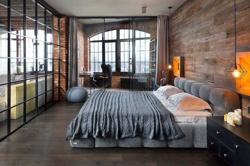 Photo of an industrial master bedroom in Other with brown walls, dark hardwood floors and brown floor.