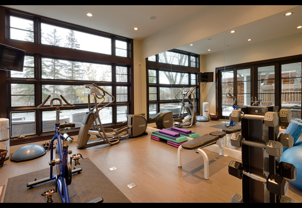 Inspiration for a transitional multipurpose gym in Calgary with beige walls and cork floors.