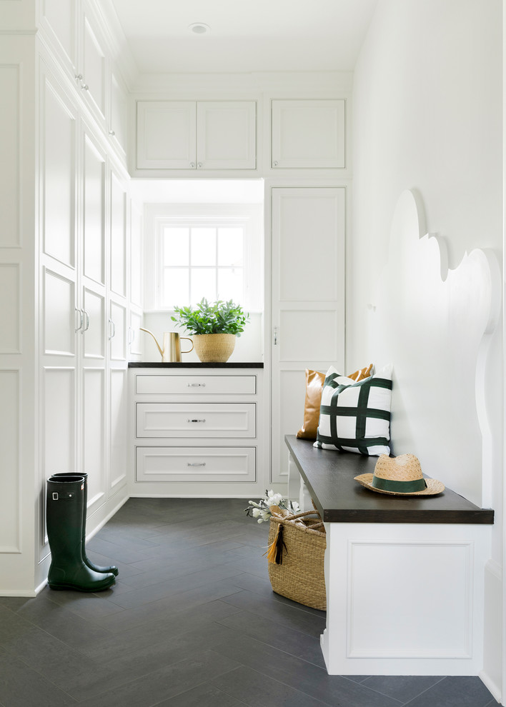 This is an example of a traditional gender-neutral walk-in wardrobe in Minneapolis with recessed-panel cabinets and white cabinets.