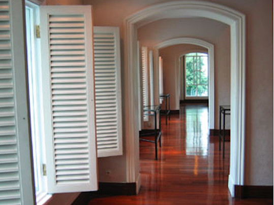 Hallway - mid-sized contemporary dark wood floor and brown floor hallway idea in Phoenix with beige walls