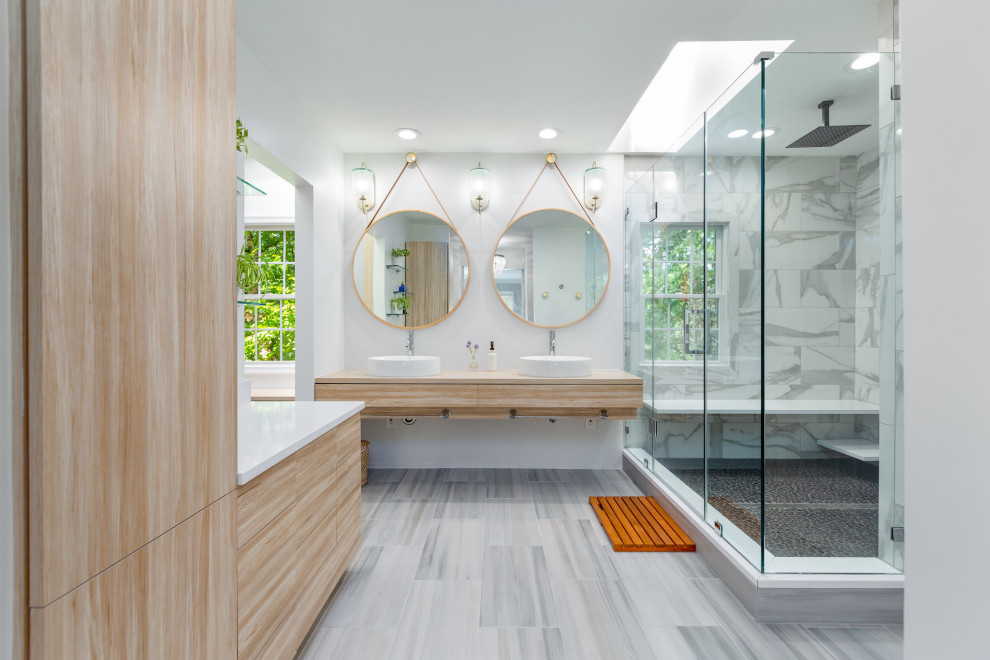 Design ideas for a contemporary bathroom in DC Metro with flat-panel cabinets, light wood cabinets, a one-piece toilet, white tile, porcelain tile, a vessel sink, engineered quartz benchtops, a hinged shower door, white benchtops, a double vanity and a floating vanity.