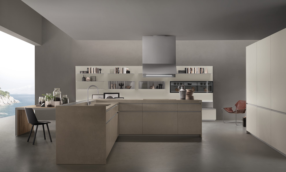 Photo of a large modern u-shaped open plan kitchen in Toronto with an integrated sink, flat-panel cabinets, beige cabinets, panelled appliances, concrete floors and with island.