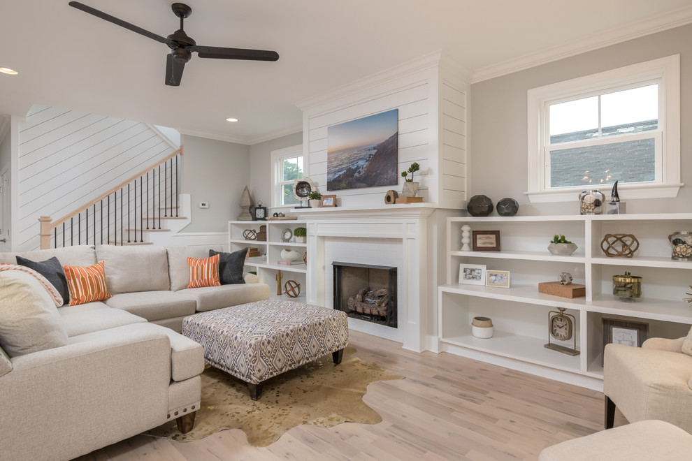 Transitional light wood floor and beige floor living room photo in Other with white walls, a standard fireplace and a tile fireplace