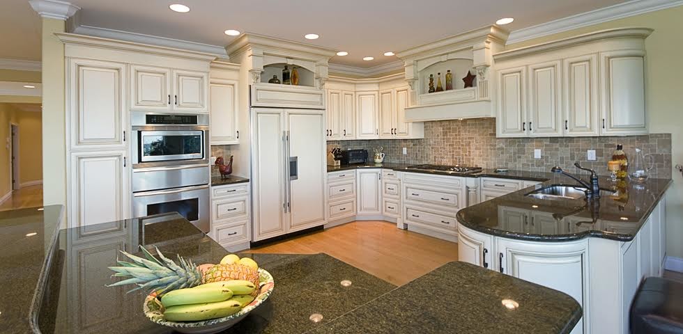 Large country u-shaped eat-in kitchen in Vancouver with a double-bowl sink, raised-panel cabinets, white cabinets, laminate benchtops, beige splashback, ceramic splashback, panelled appliances, light hardwood floors and a peninsula.